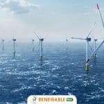 "Offshore wind turbines in the ocean, with white poles and red-tipped blades,