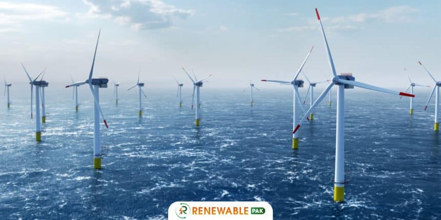 "Offshore wind turbines in the ocean, with white poles and red-tipped blades,